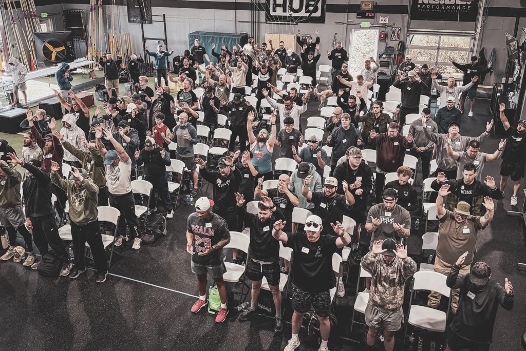 Overhead view of men worshipping with hands raised during a session at Launching Pad