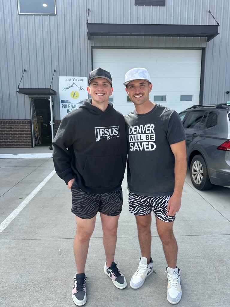 Two men standing outside wearing Jesus Is and Denver Will Be Saved apparel